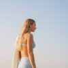 Model wearing Lola high waisted swim shorts in Puffy Seashell Ocean with matching Sasha balconette bikini top