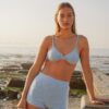Model wearing Lola high waisted swim shorts in Puffy Seashell Ocean with matching Sasha balconette bikini top